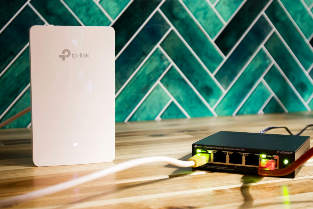 Wi-Fi access point and network switch on a desk, part of a small office network where a printer can be added by IP address