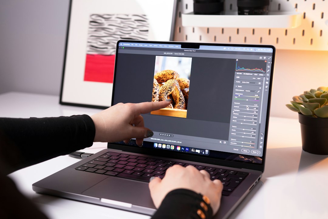 Person working on images on a laptop, batch converting a folder of BMP files to JPG