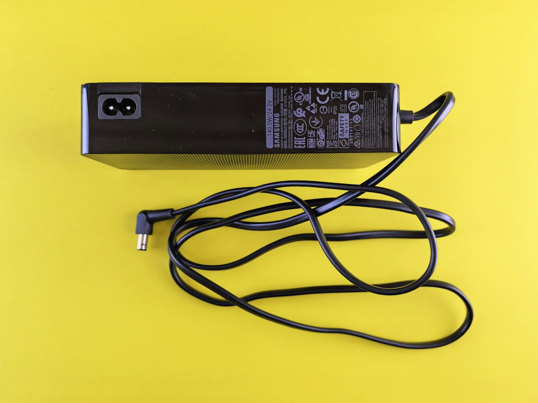 Black laptop power adapter and cord, worth checking for wattage and damage when a laptop won't charge