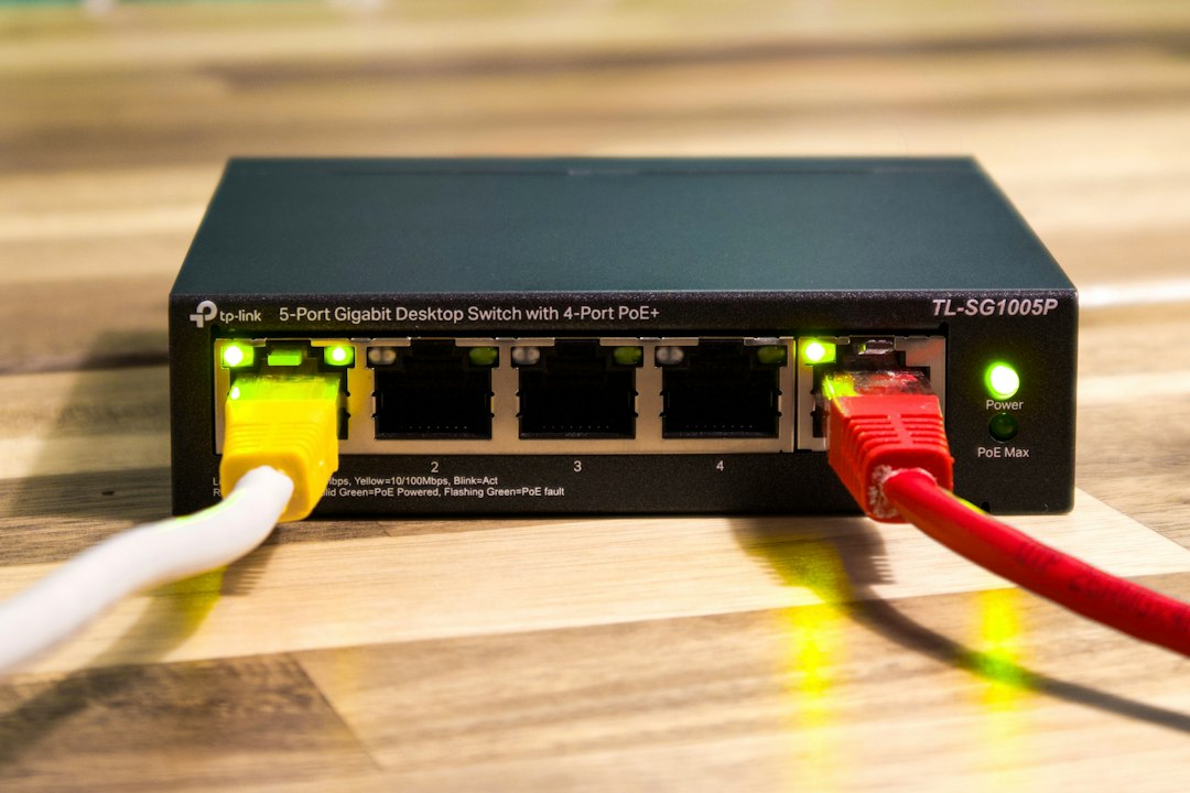 Network switch with green link lights and Ethernet cables plugged in