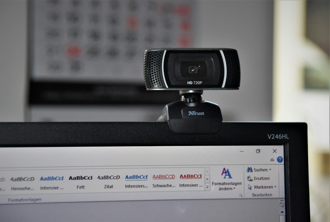 External USB webcam mounted on top of a monitor in a home office