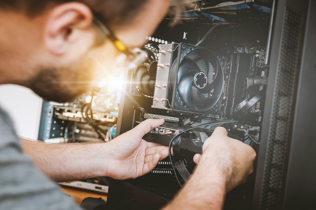 Person working inside a desktop PC case to check drive cables and connections