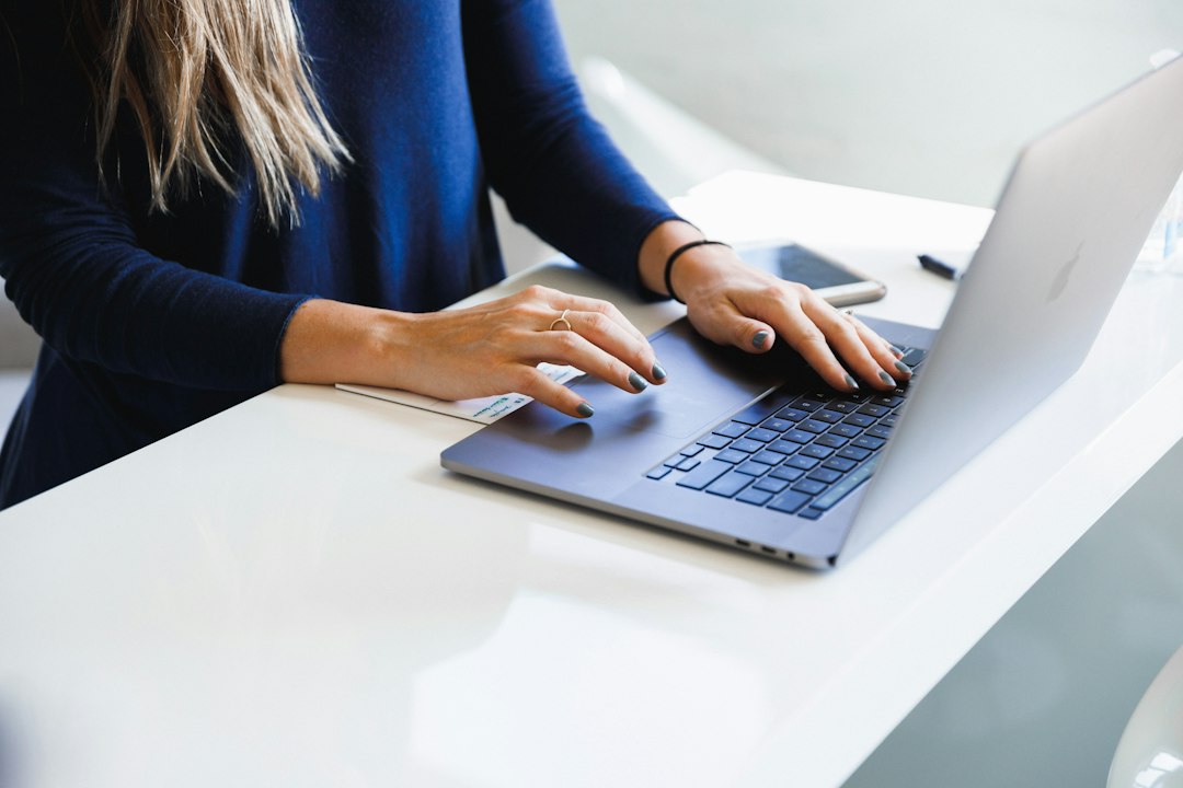 Person working on a laptop, installing a manufacturer's driver to fix Code 28