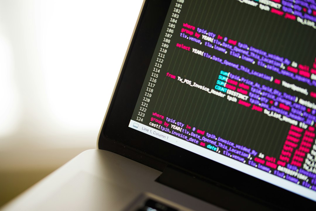 Laptop showing program code, where a Java app fails to start with a virtual machine error