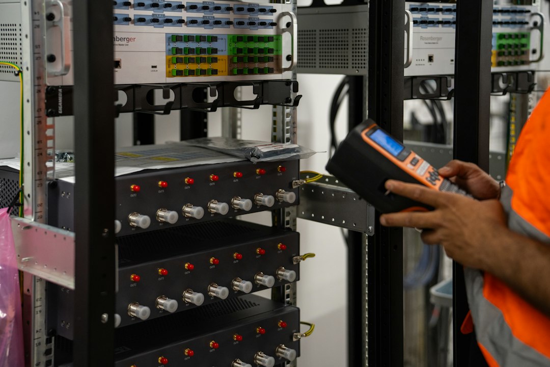 Technician checking server racks, where the domain controller holds the computer account that needs resetting