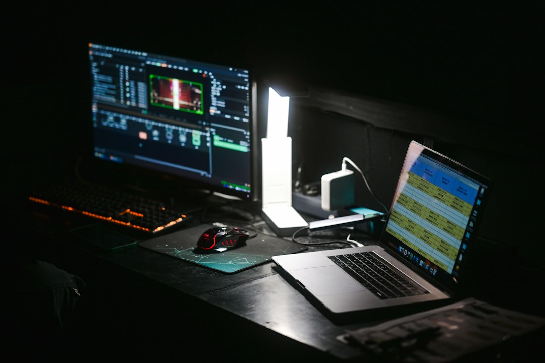 Laptop and monitor on a desk, set up for working in Excel with keyboard shortcuts