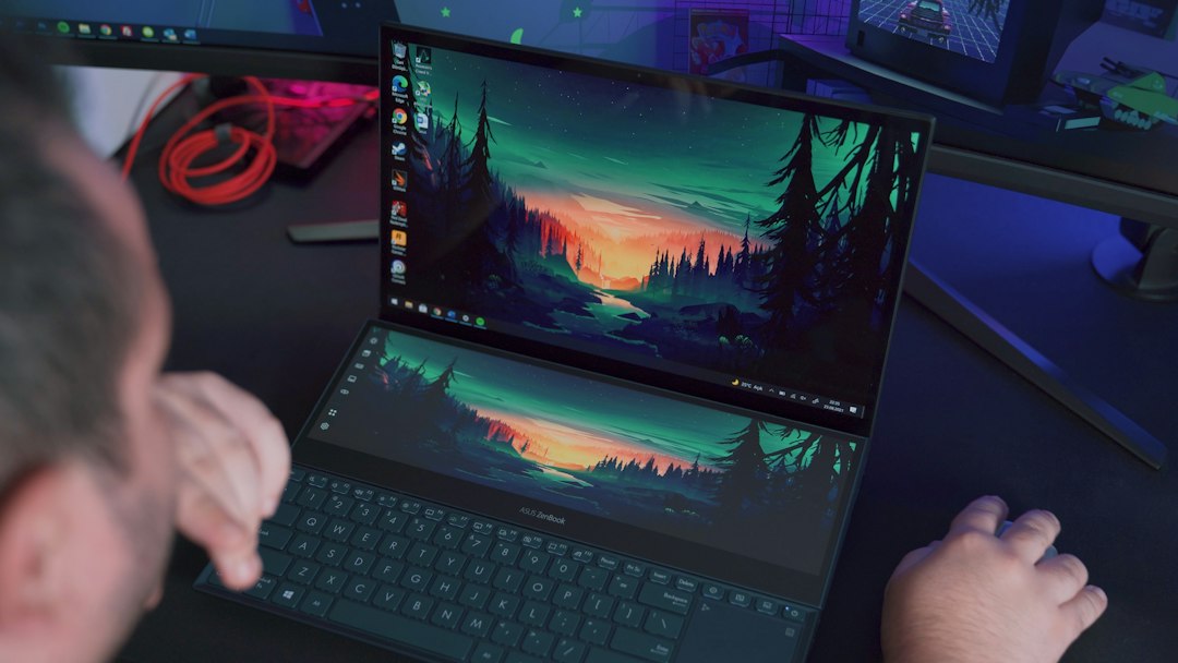 Laptop on a desk, where Windows Wi-Fi settings show the SSID of the connected network