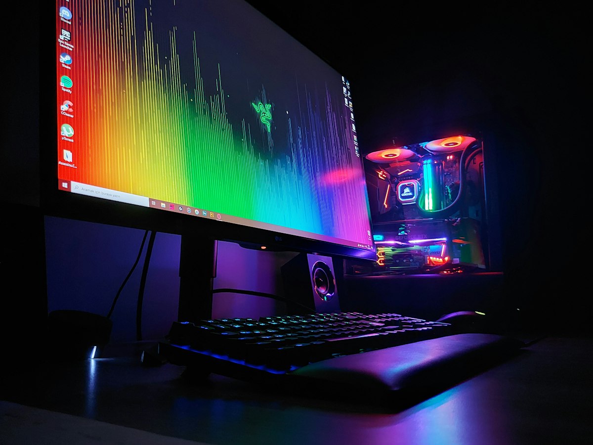 Gaming PC monitor and keyboard on a desk, where an older NVIDIA driver may need repairing to bring back the Control Panel