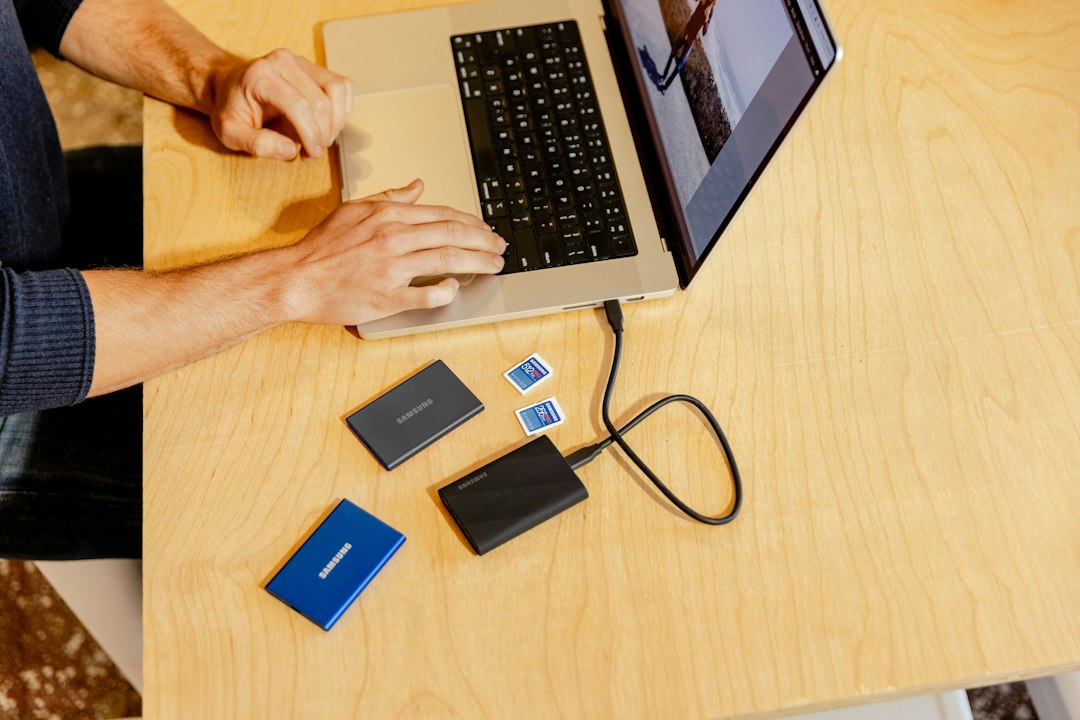 Person working on a laptop at a table, about to recover deleted files
