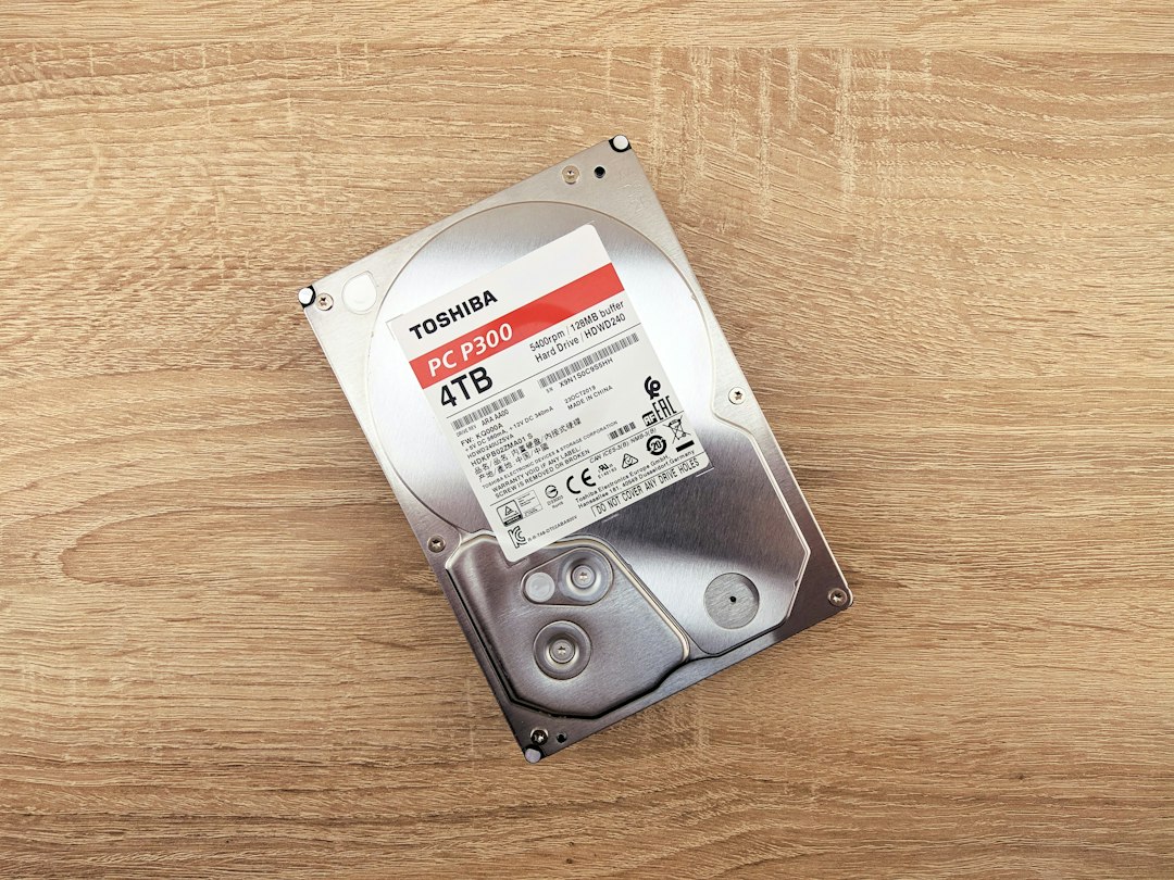 Hard drive on a wooden table, representing cleaning up leftover Windows update files