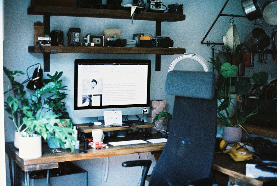 Computer monitor on a wooden desk, used to scan documents from an HP Envy 4500 printer