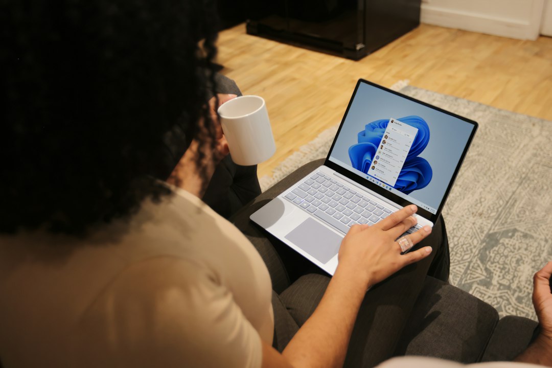 Person using a Windows laptop, where Microsoft Edge can be repaired from Settings