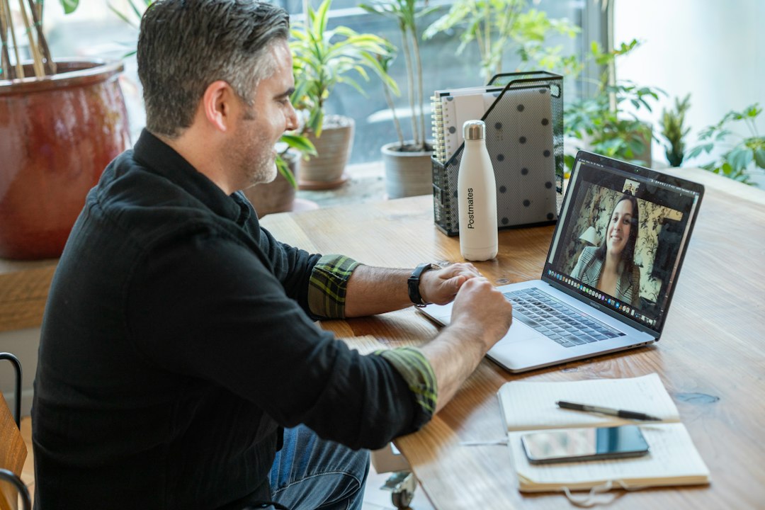 Office worker on a video call at a laptop, using Microsoft Teams tips to work faster