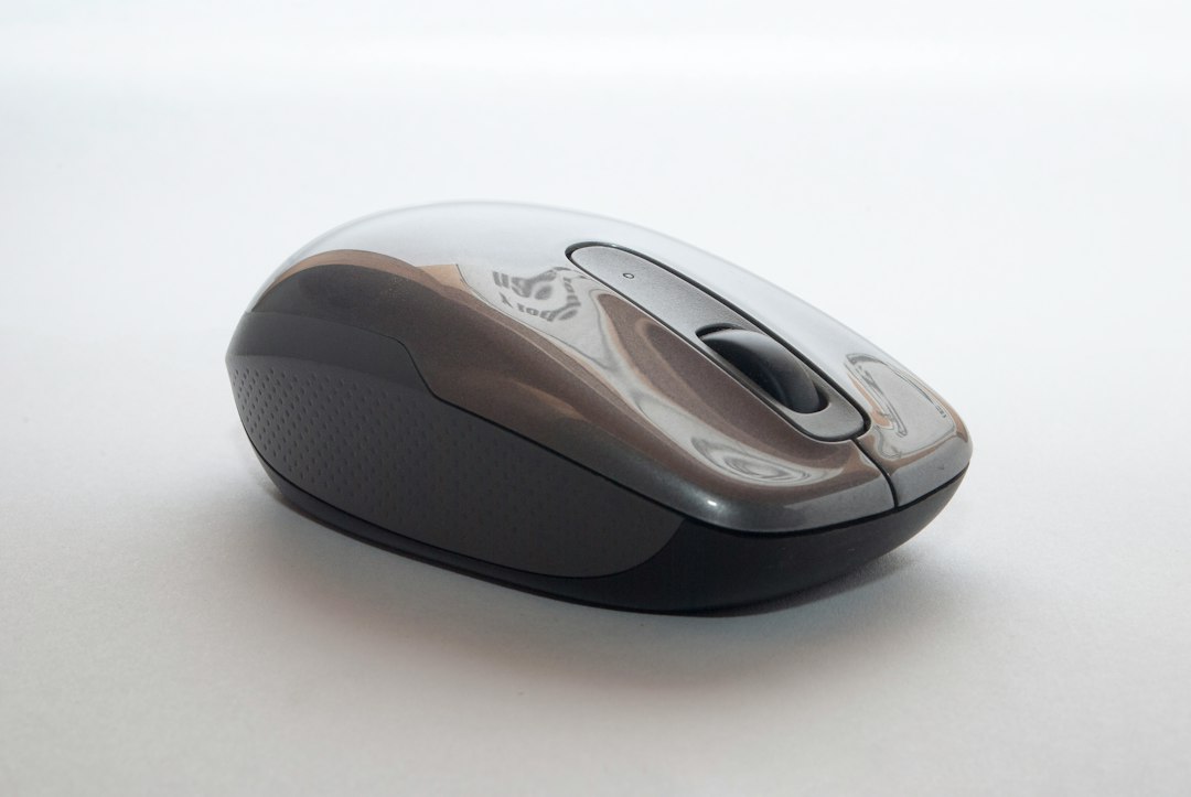 Close-up of a wireless mouse scroll wheel, a common cause of Windows 10 scrolling down by itself