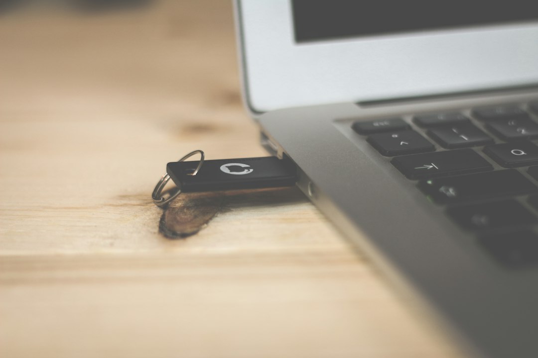 Laptop with a USB stick beside it, ready to repair the Windows recovery partition