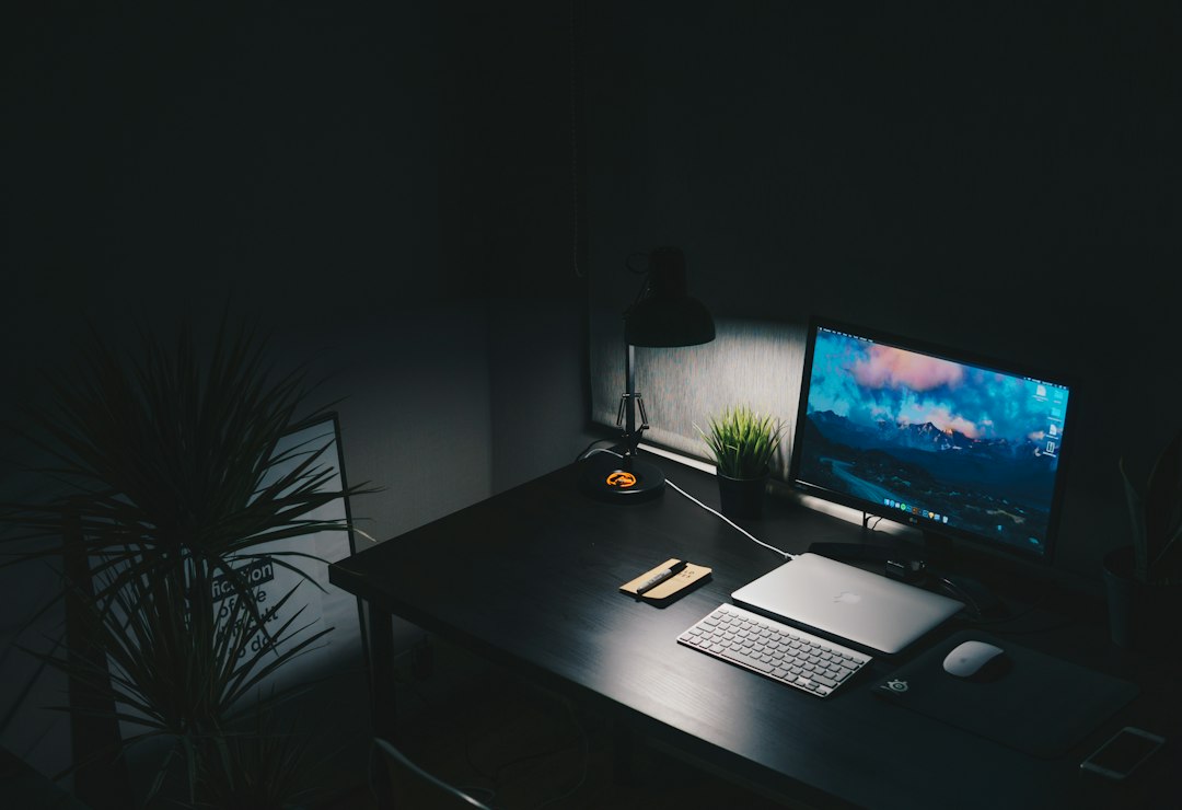 Desk with a computer monitor and keyboard, representing resetting the graphics driver when a monitor has no signal