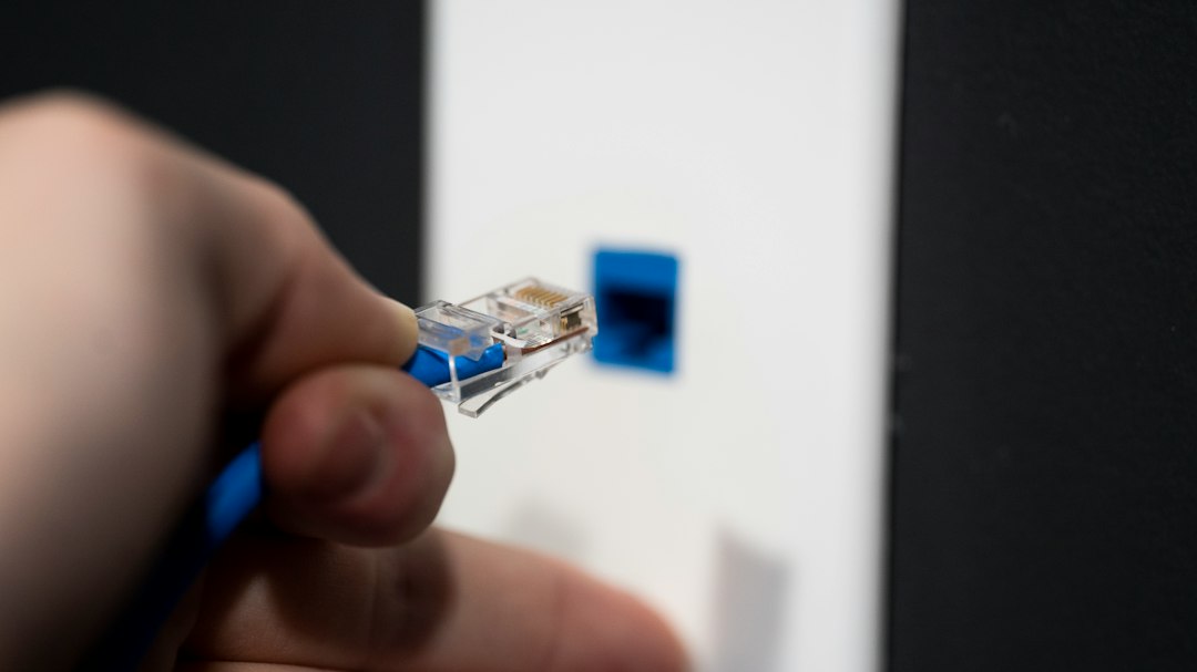 Plugging in an Ethernet cable, representing resetting the network connection for Discord voice chat