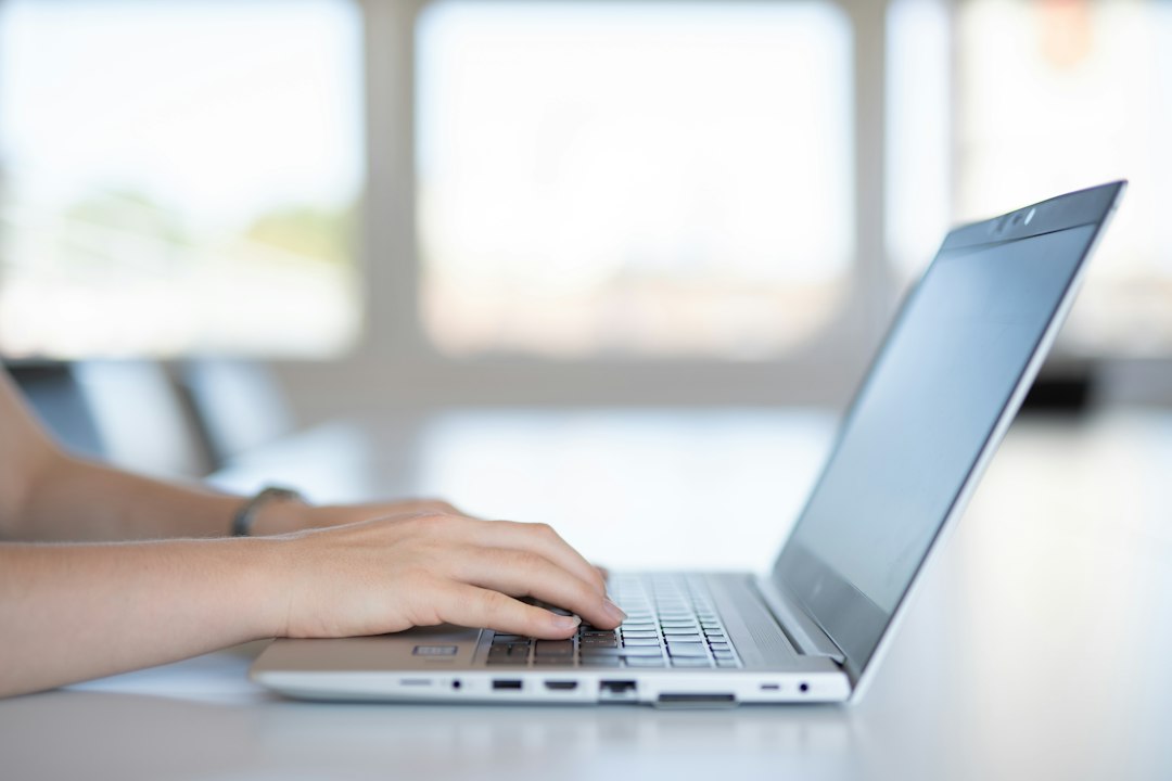 Close-up of hands on a laptop keyboard, showing field codes to find every hyperlink in Word