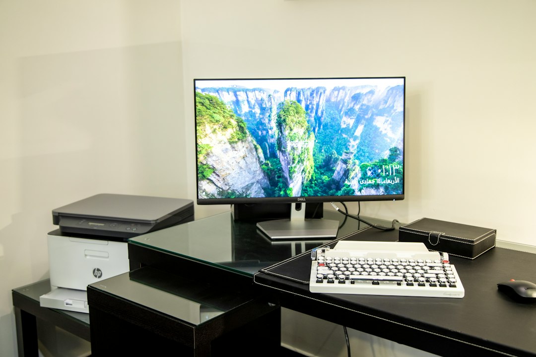 Desktop PC with a monitor and a multifunction printer beside it, set up as the primary PC