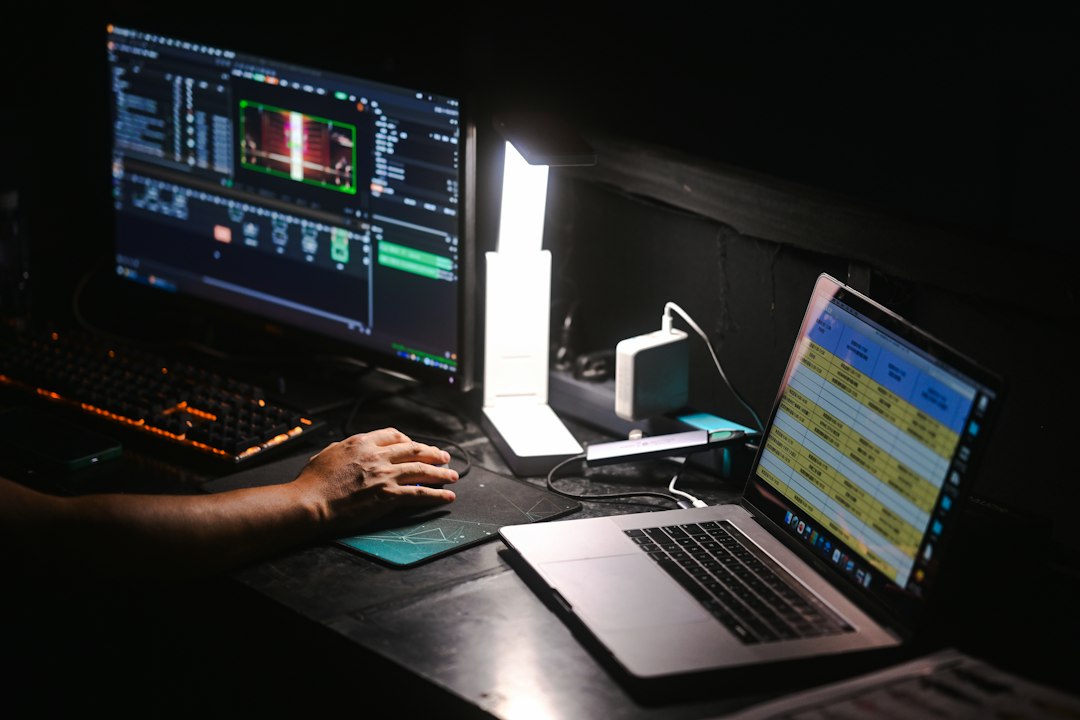 Hand using a computer mouse at a desk, representing Shift and drag to move a row in Excel