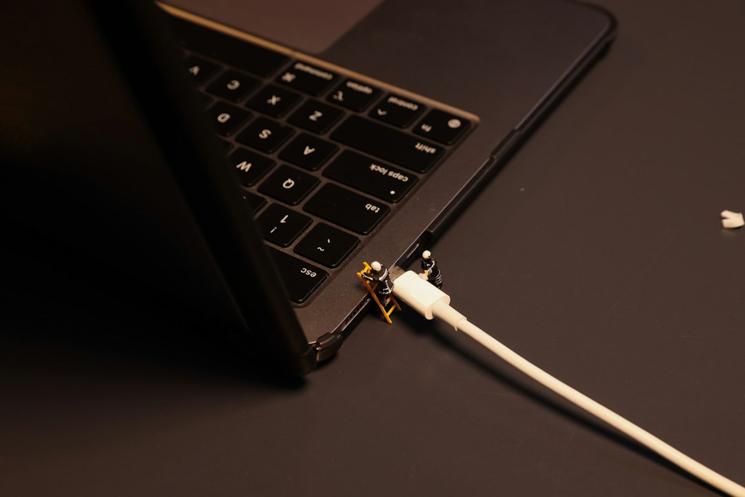 Laptop plugged into power, representing suspending BitLocker before a BIOS or firmware update