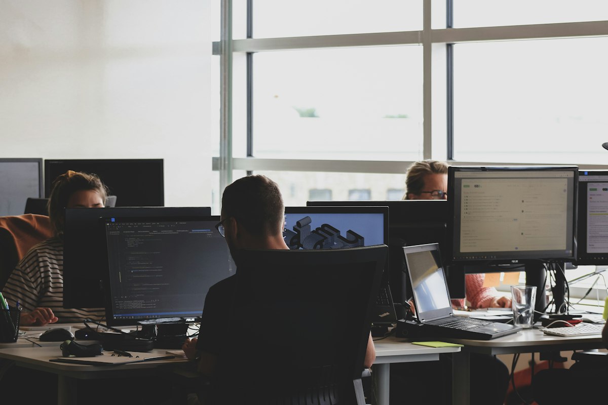 IT staff at computer monitors building a clean-install Windows reference image for Sysprep