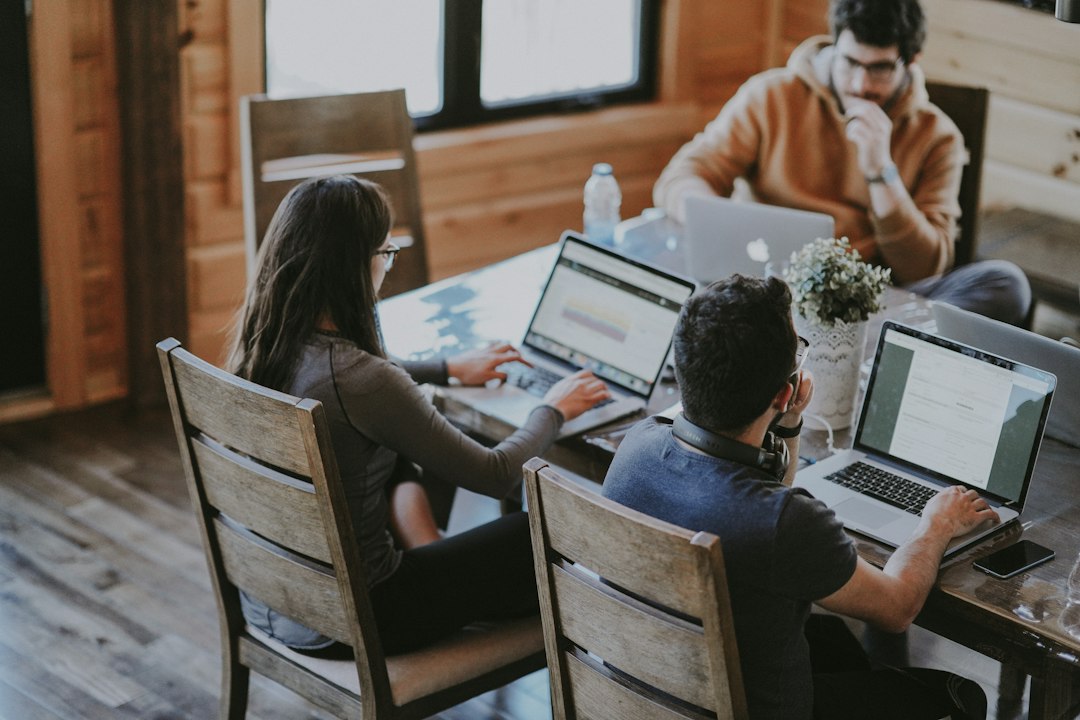 Team working together at a table, the kind of group that shares one support or sales mailbox