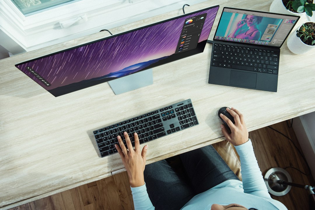 Person using a laptop at a table, representing testing whether the left mouse button is worn out