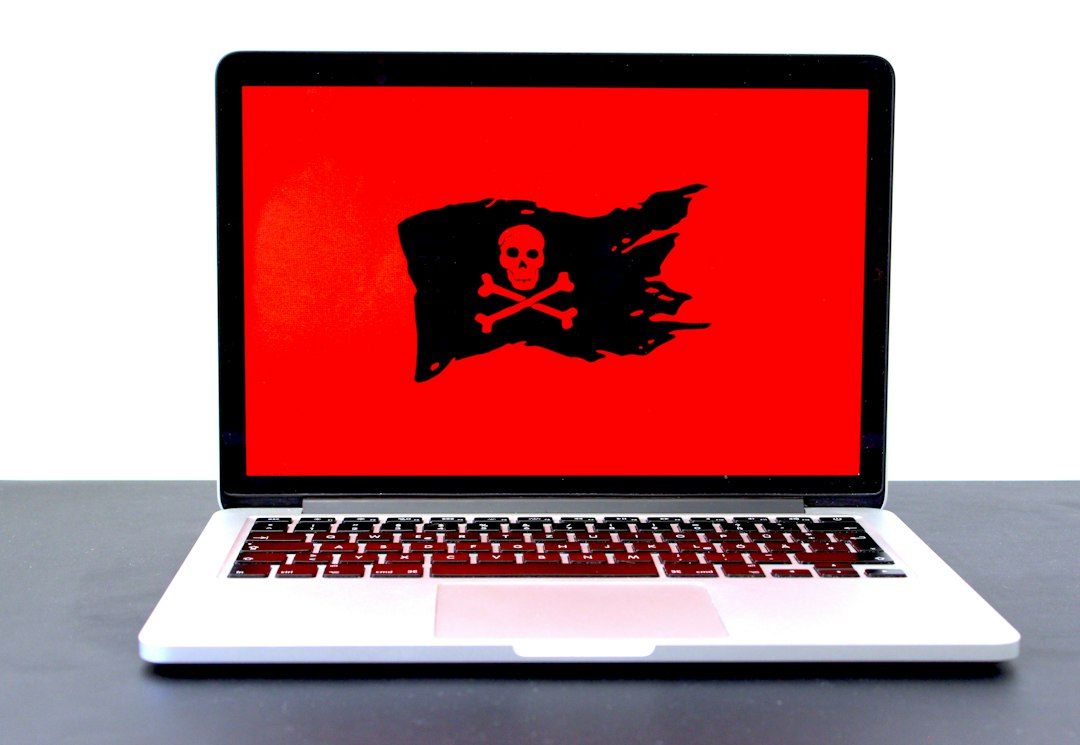 Laptop showing a red warning screen, representing the Threat service has stopped message in Windows Security