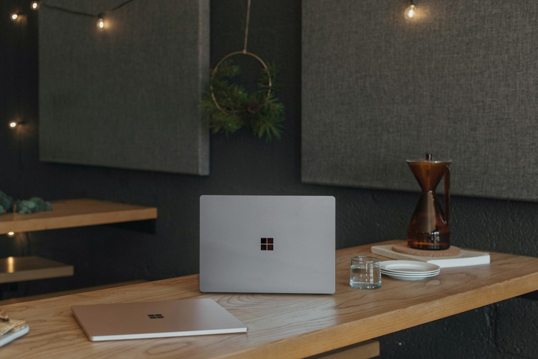 Surface laptops on a desk, used to turn off Copilot in Word, Excel and PowerPoint
