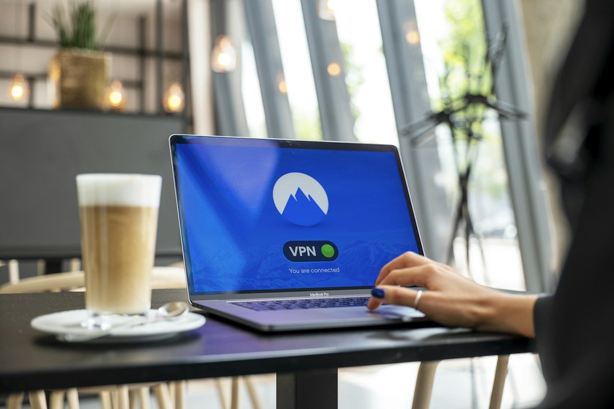 Person using a laptop for a VPN connection that runs through Windows' WAN Miniport adapters