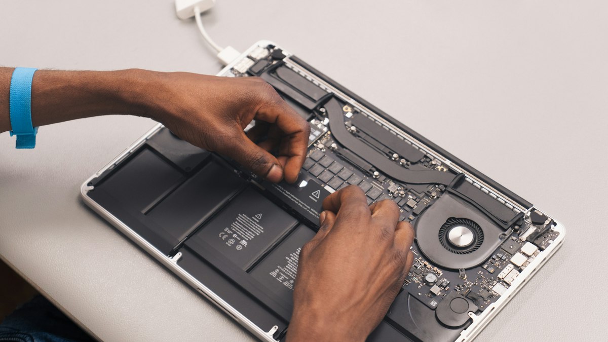 Laptop open on a repair bench, ready to be checked after an offline system file repair