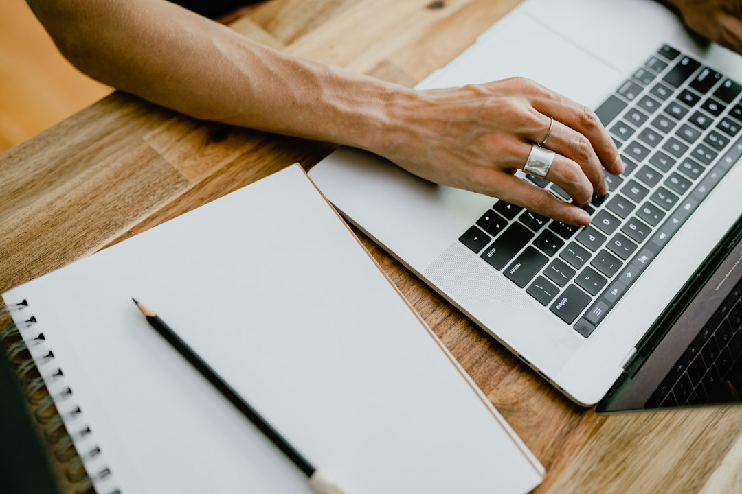 Person typing in a document on a laptop, where Word may show Product Activation Failed