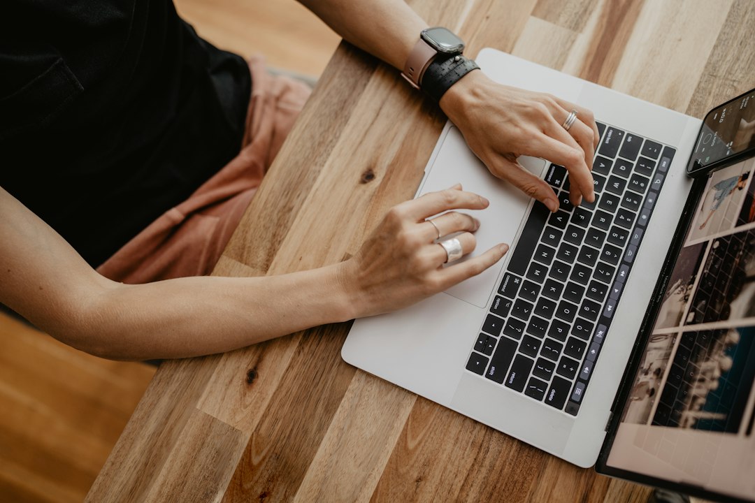 Hands typing on a laptop keyboard, representing formatting a Word document with styles and shortcuts