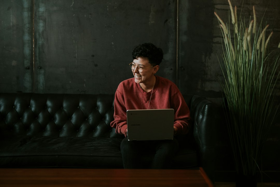 Person using a laptop at home, where a work or school account can be disconnected and reconnected
