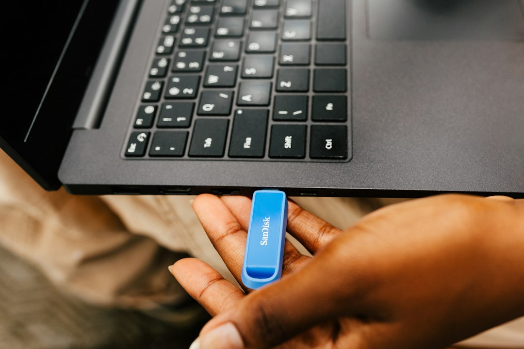 USB drive connected to a phone and laptop, showing why FAT32 or exFAT matters for compatibility between devices