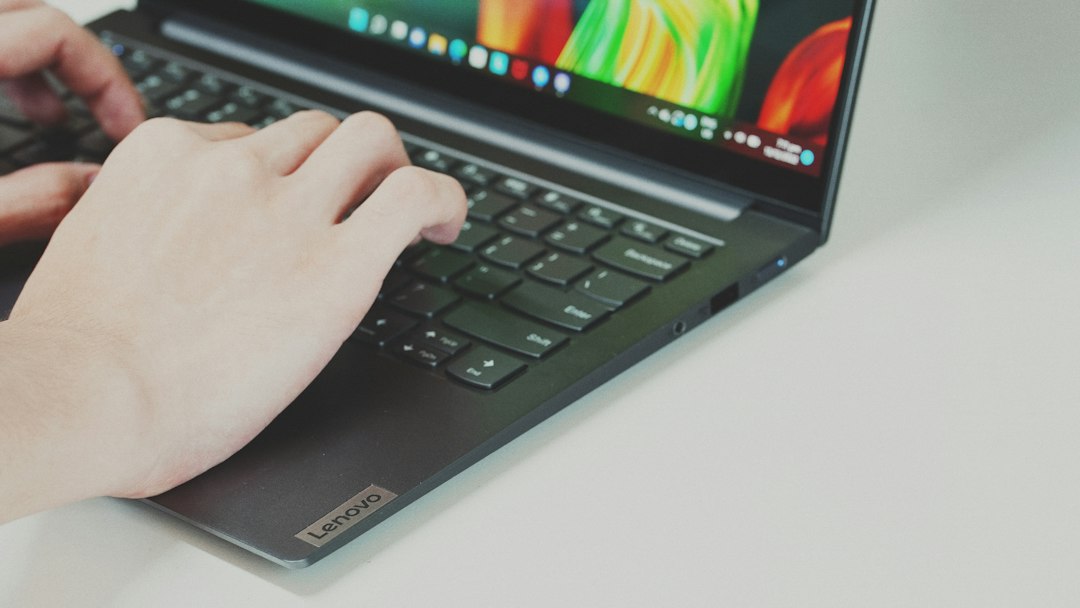 Hands typing on a laptop while resetting a Microsoft account password