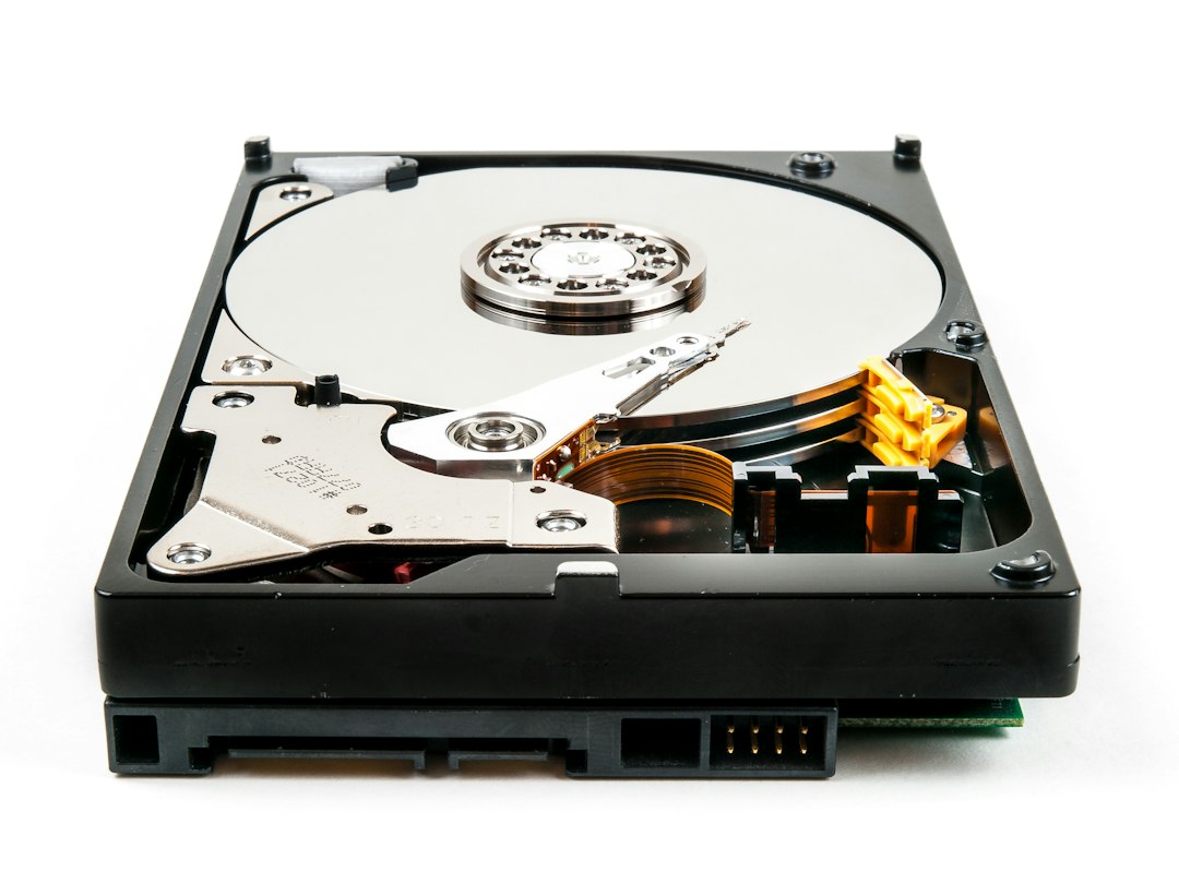 Opened hard disk drive showing the platter and read/write arm