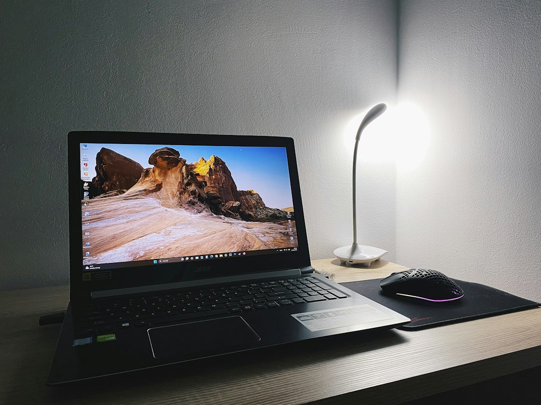 Laptop on a wooden desk set to shut down daily with Task Scheduler